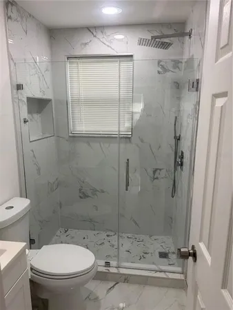 a bathroom with a toilet and a shower