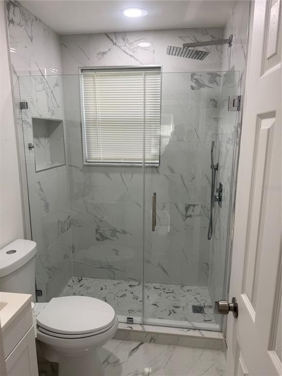 305 Ann Street Edgewater, FL 32132 - Photo 12 of 45 a bathroom with a toilet and a shower