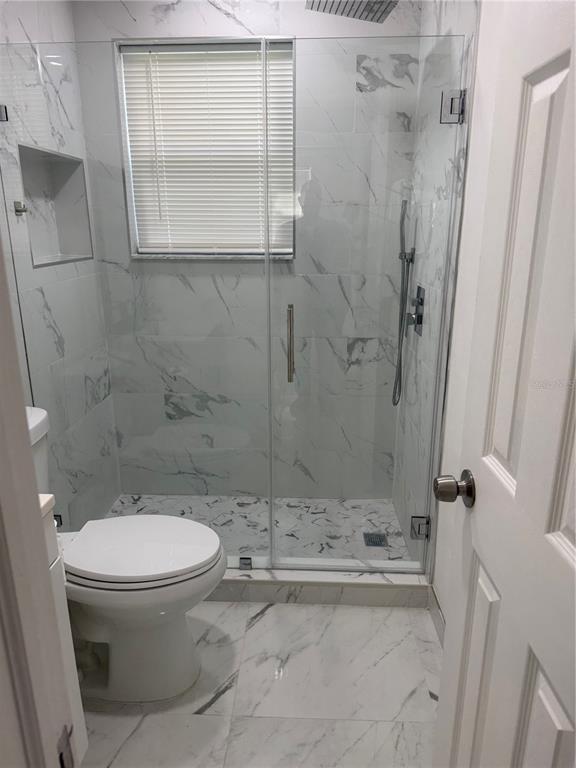 305 Ann Street Edgewater, FL 32132 - Photo 14 of 45 a bathroom with a toilet and a shower