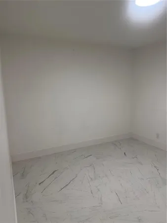 a kitchen with white cabinets and a fireplace