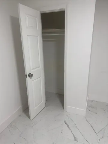 a kitchen with white cabinets stainless steel appliances and sink