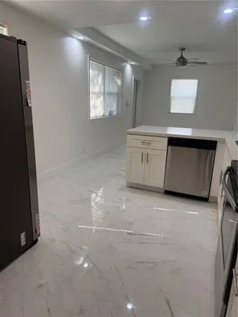 a kitchen with stainless steel appliances a refrigerator sink and microwave