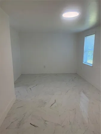 a white toilet sitting next to a window