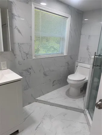 a bathroom with a shower and toilet