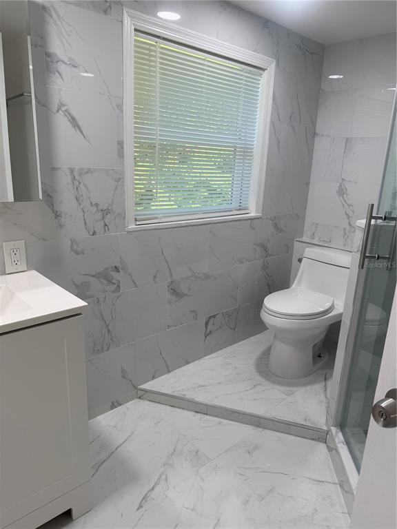 305 Ann Street Edgewater, FL 32132 - Photo 39 of 45 a bathroom with a toilet sink and a shower