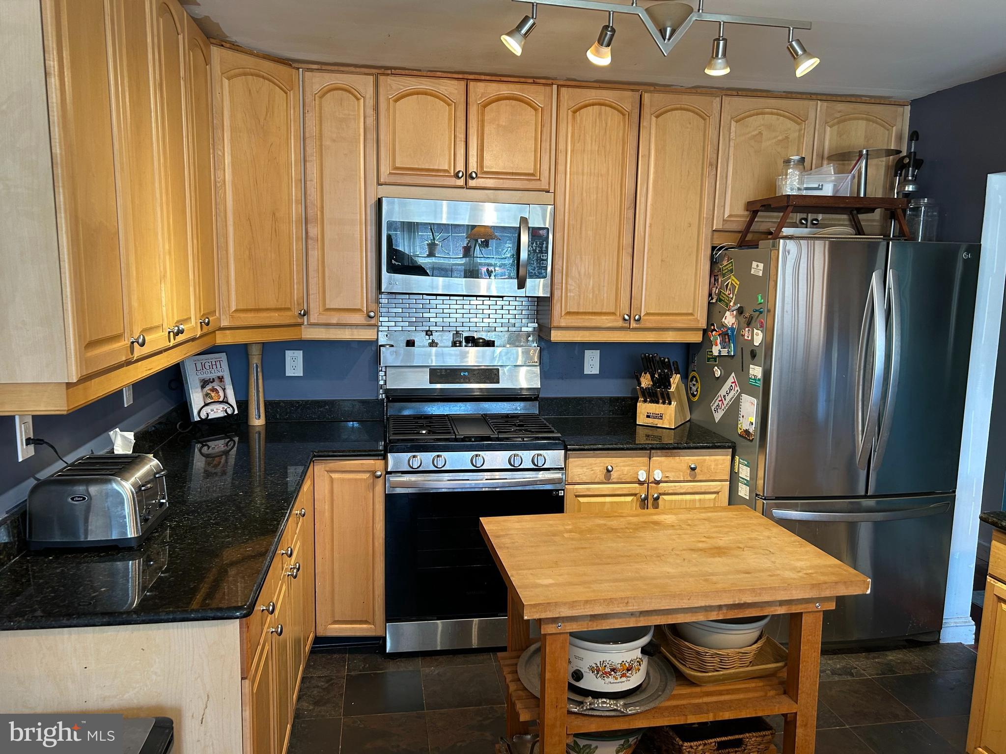 2217 Westview Drive Silver Spring, MD 20910 - Photo 1 of 4 a kitchen with stainless steel appliances granite countertop a stove refrigerator sink and cabinets