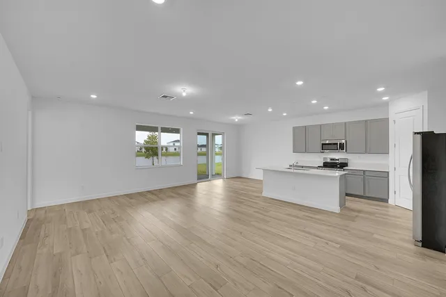 a view of kitchen with stove and refrigerator