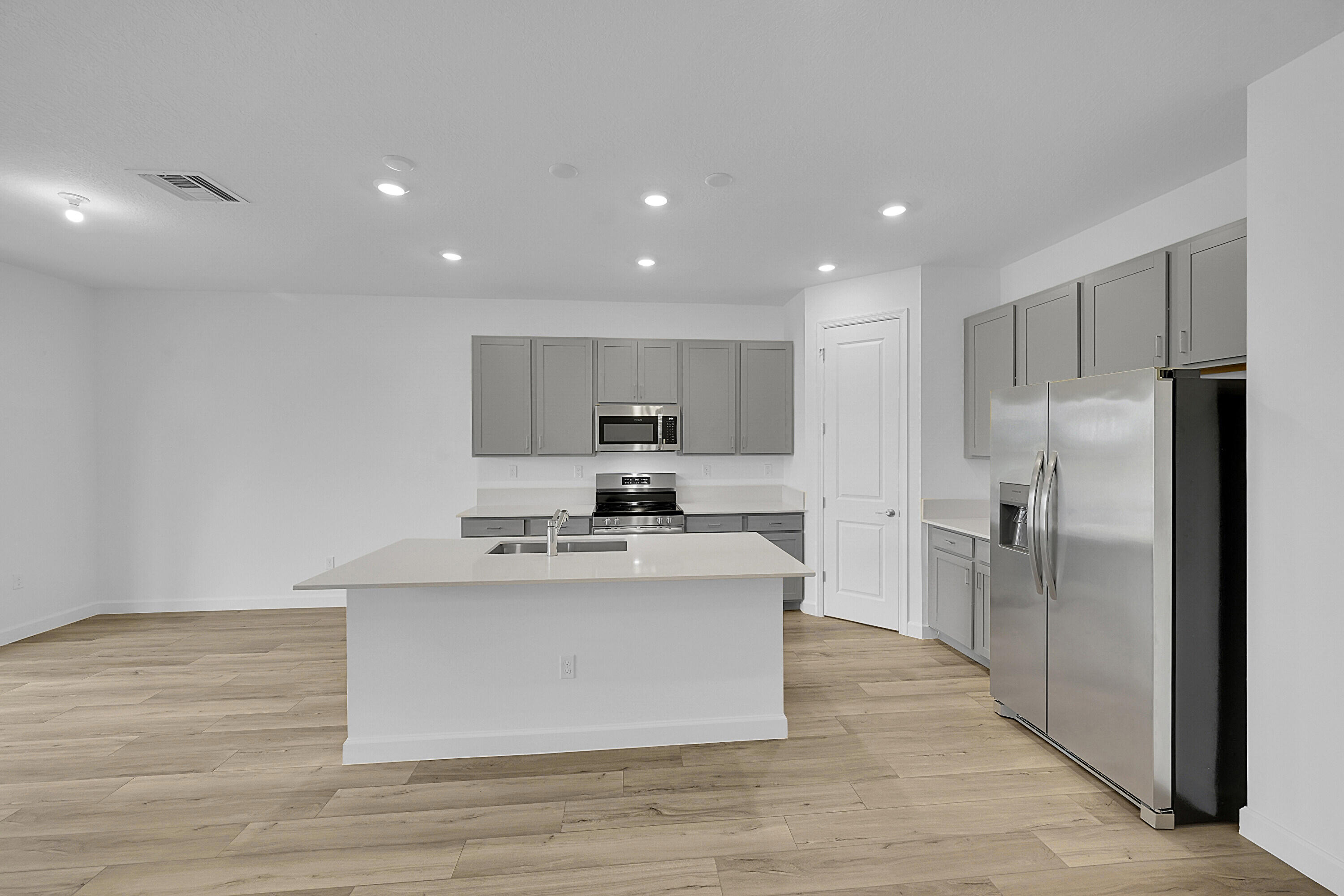 3501 Harborside Avenue Fort Pierce, FL 34946 - Photo 17 of 31 a large kitchen with stainless steel appliances a large counter top and a refrigerator