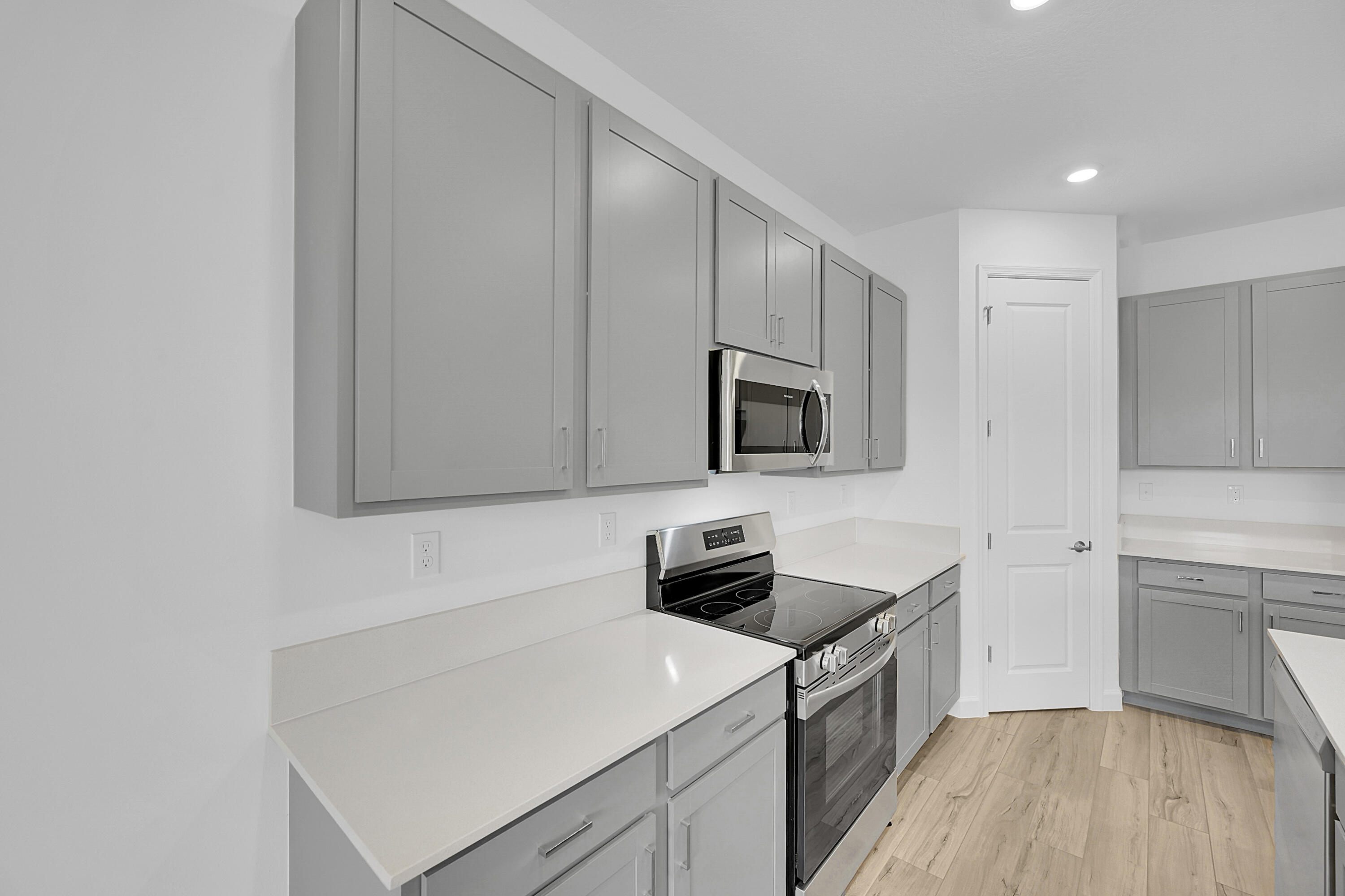 3501 Harborside Avenue Fort Pierce, FL 34946 - Photo 18 of 31 a kitchen with white cabinets and stainless steel appliances