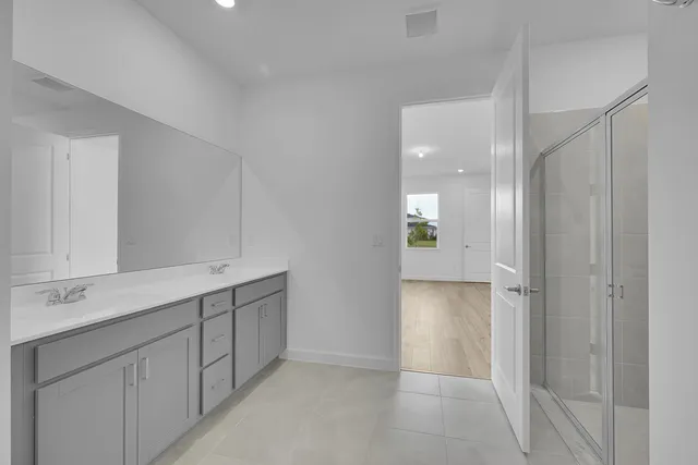 a bathroom with a double vanity sink and mirror