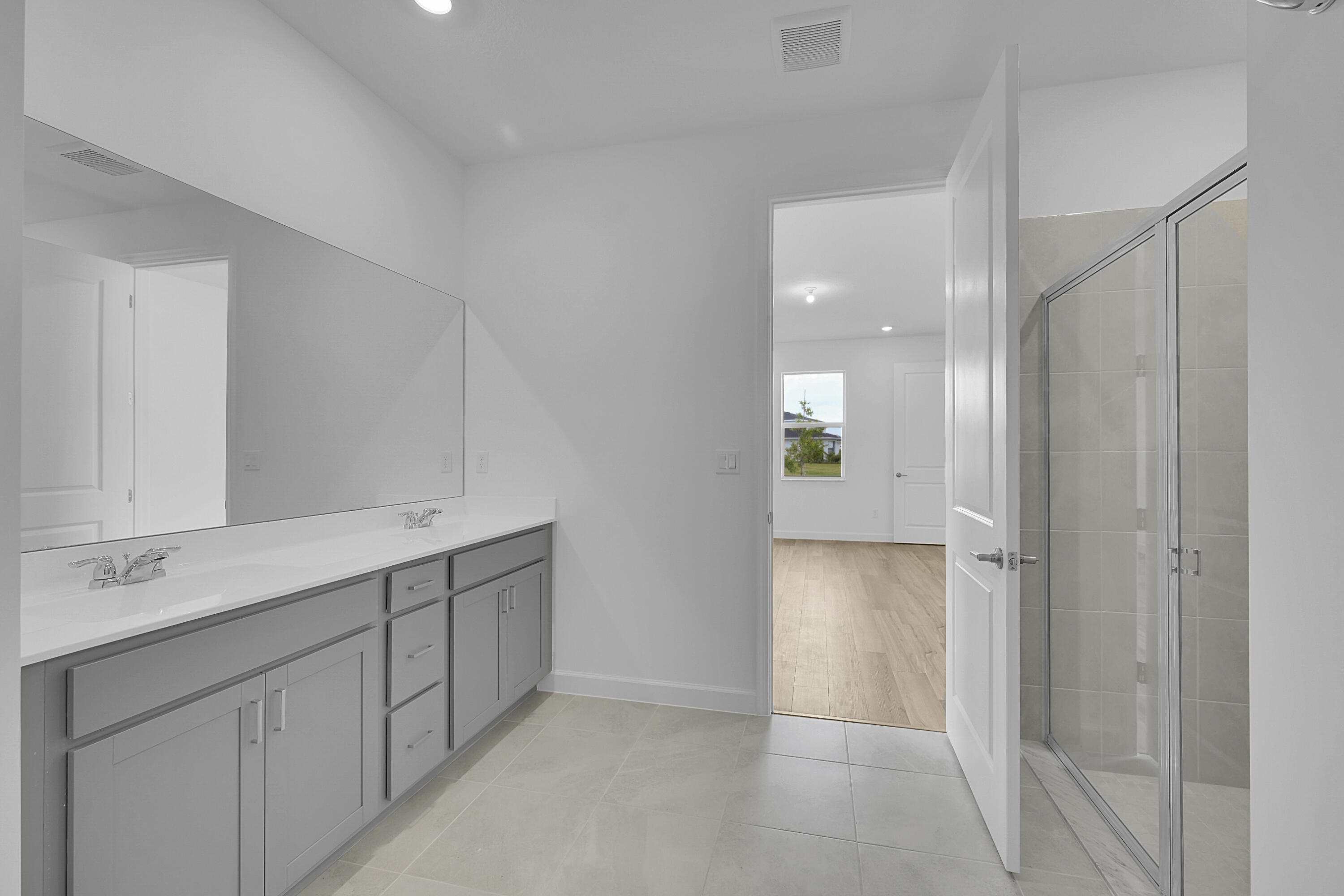 3501 Harborside Avenue Fort Pierce, FL 34946 - Photo 22 of 31 a bathroom with a double vanity sink and mirror