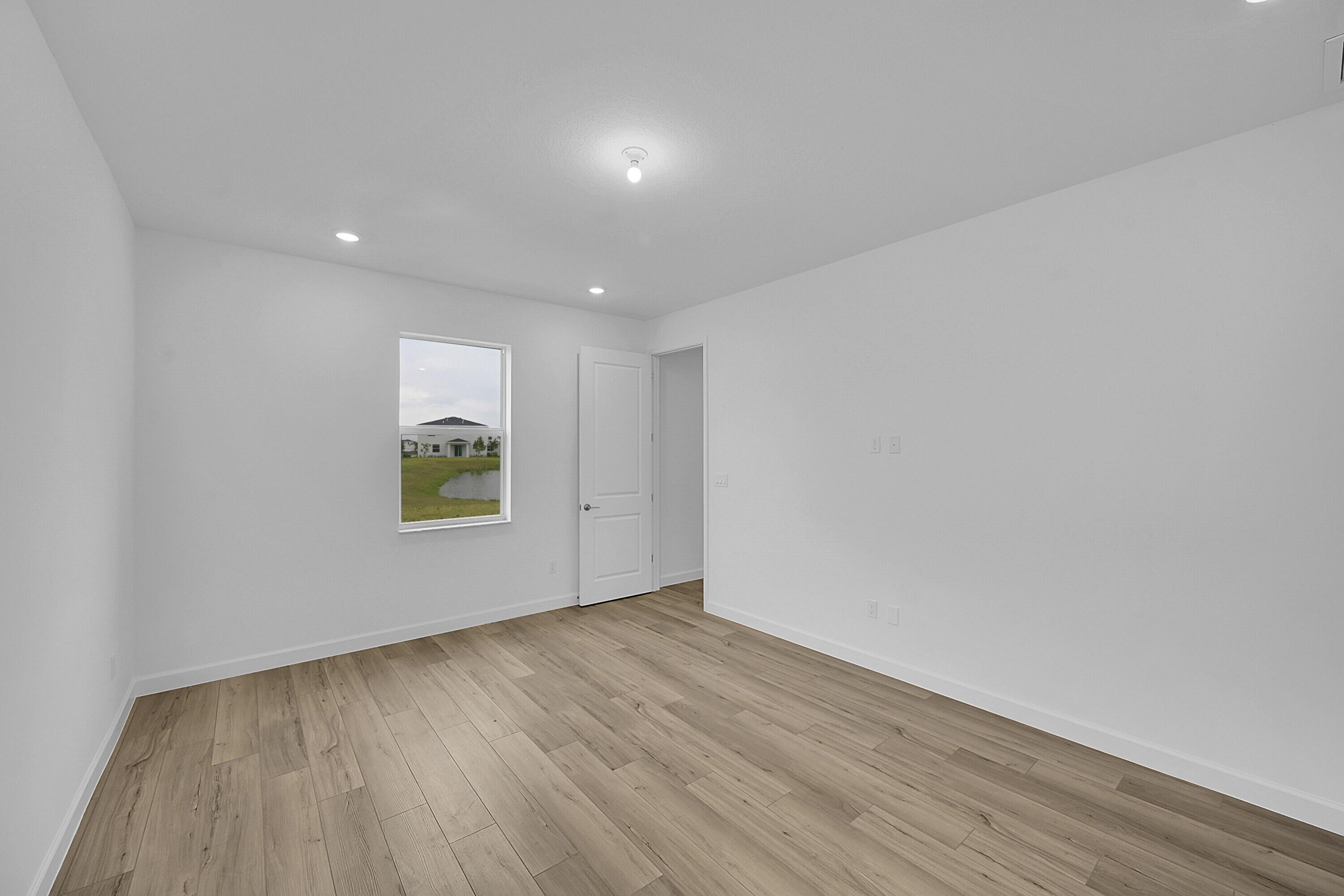 3501 Harborside Avenue Fort Pierce, FL 34946 - Photo 24 of 31 a view of an empty room with wooden floor and a window