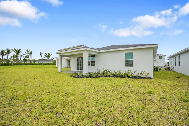 a front view of house with yard and lake view