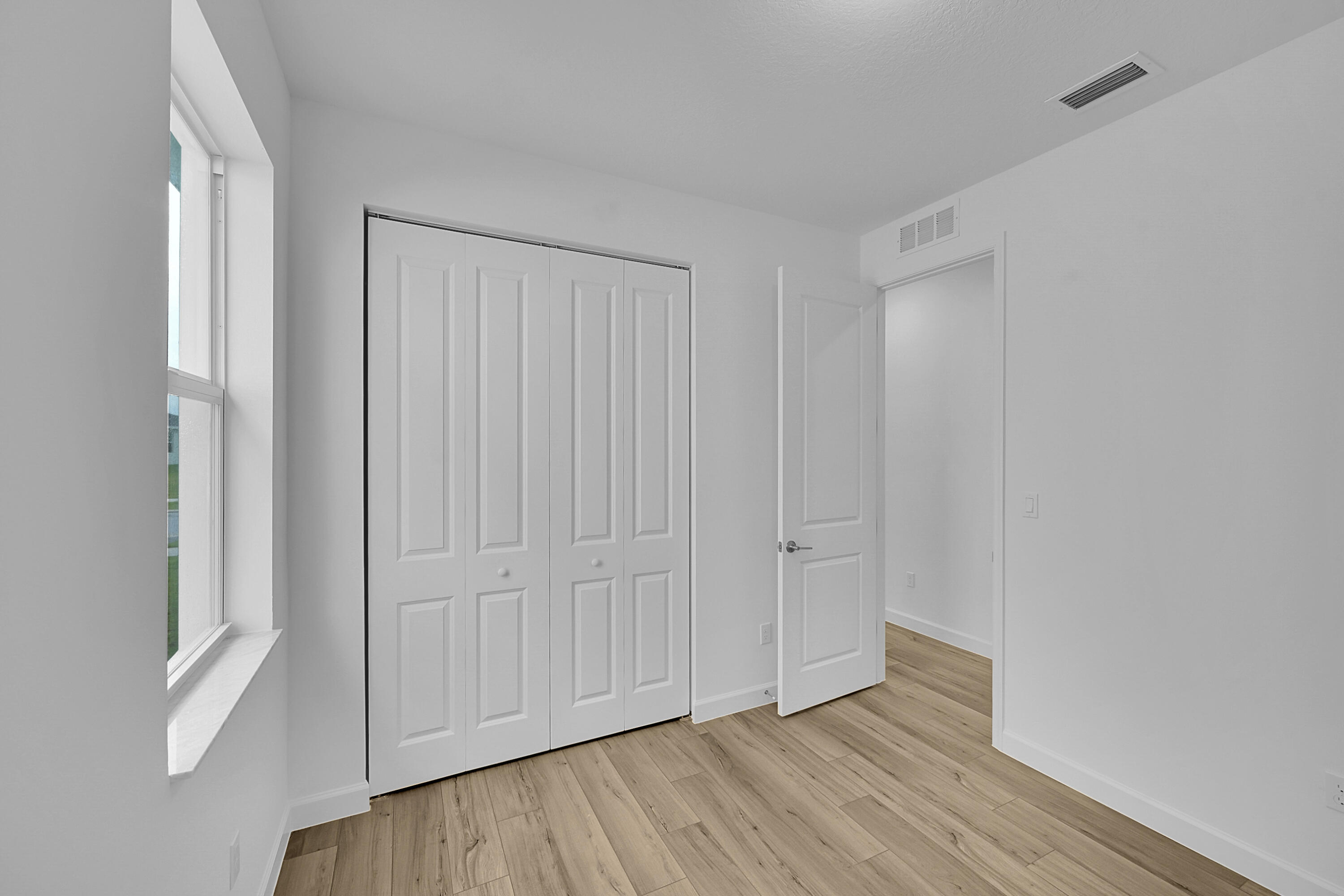 3501 Harborside Avenue Fort Pierce, FL 34946 - Photo 10 of 31 a view of an empty room with closet and wooden floor