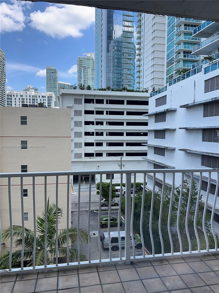 Edgewater Miami, FL 33137 - Photo 25 of 29 a view of a balcony with wooden floor and fence