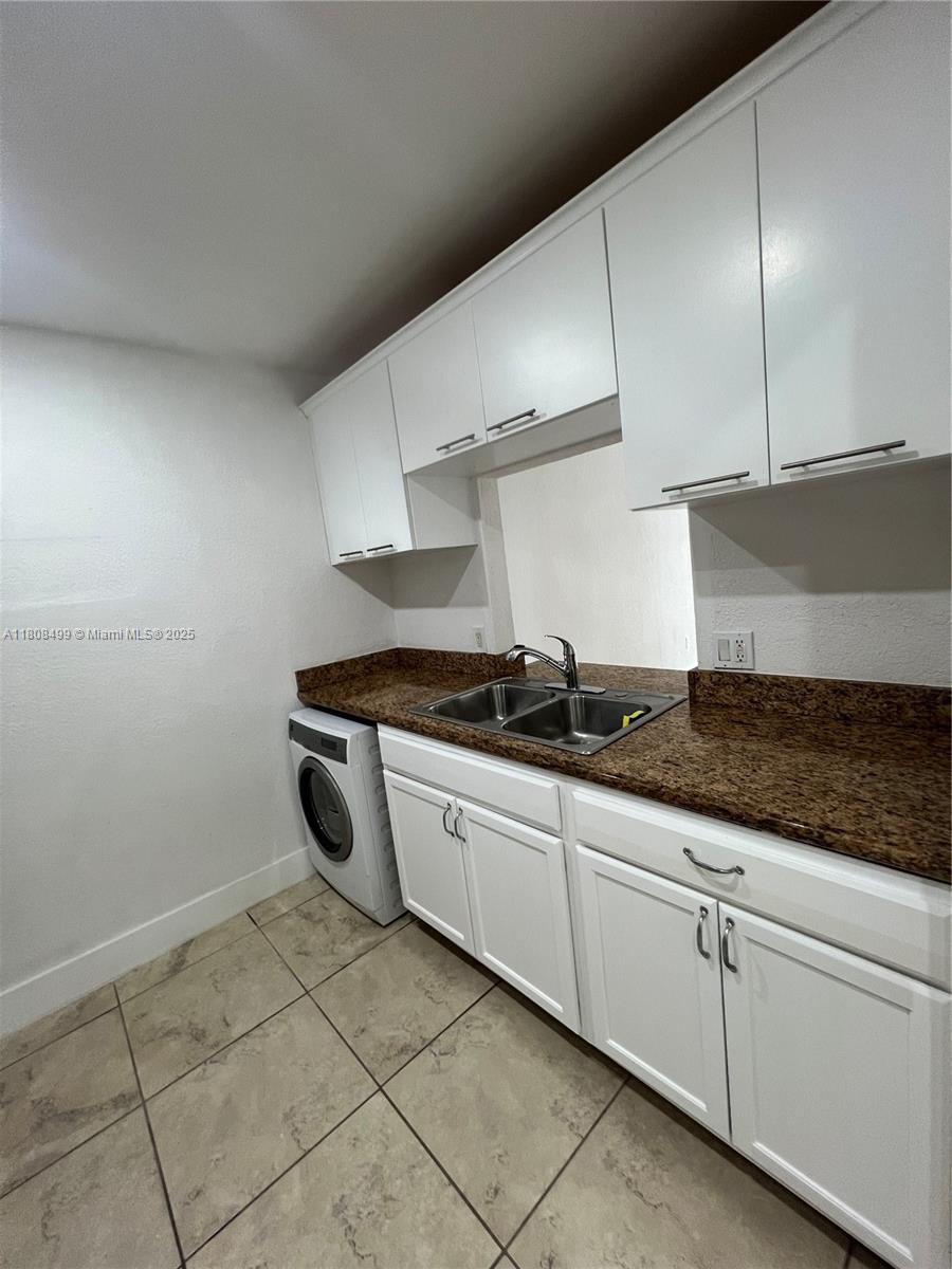 Edgewater Miami, FL 33137 - Photo 9 of 29 a kitchen with granite countertop a sink and a stove