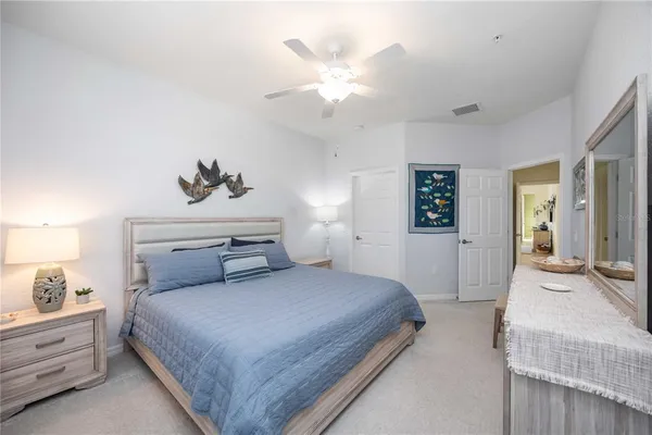 a bedroom with a large bed and a chandelier