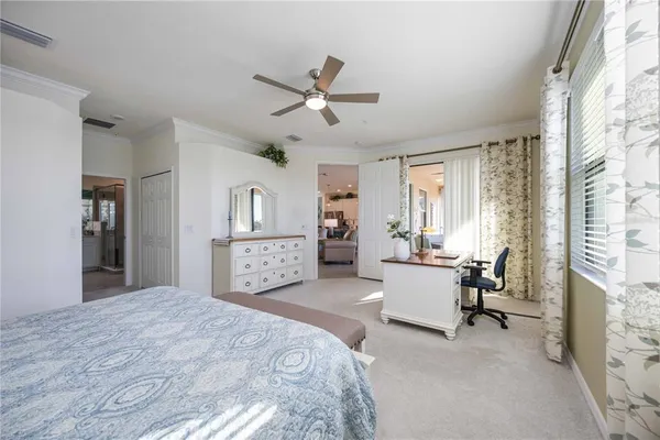 a living room with furniture a chandelier and a window