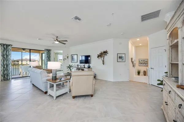 a kitchen with stainless steel appliances a dining table chairs stove and white cabinets
