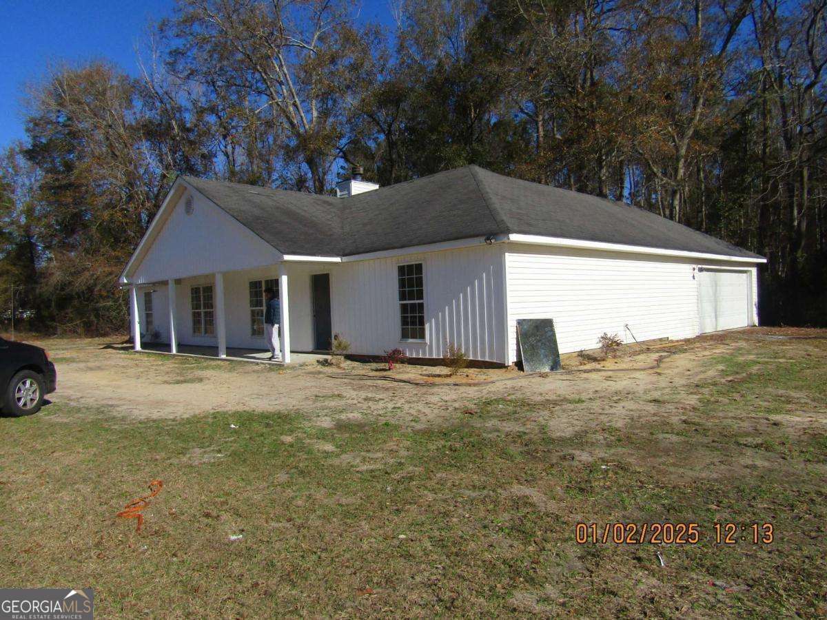 7358 Stilson-Leefield Road Brooklet, GA 30415 - Photo 2 of 24 a front view of a house with a garden and tree