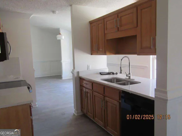 a kitchen with a sink and a refrigerator