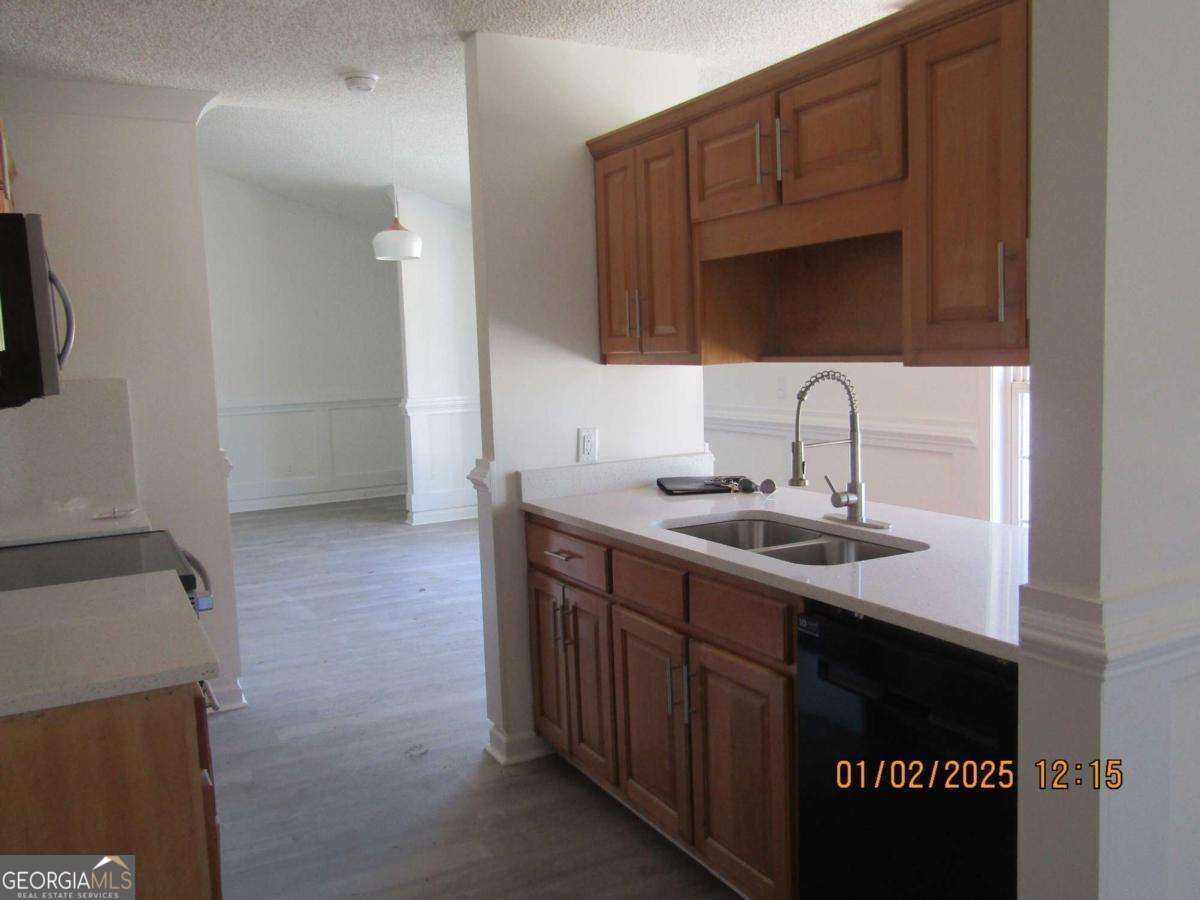 7358 Stilson-Leefield Road Brooklet, GA 30415 - Photo 6 of 24 a kitchen with a sink and a refrigerator
