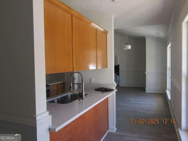 a kitchen with stainless steel appliances granite countertop a sink and a stove