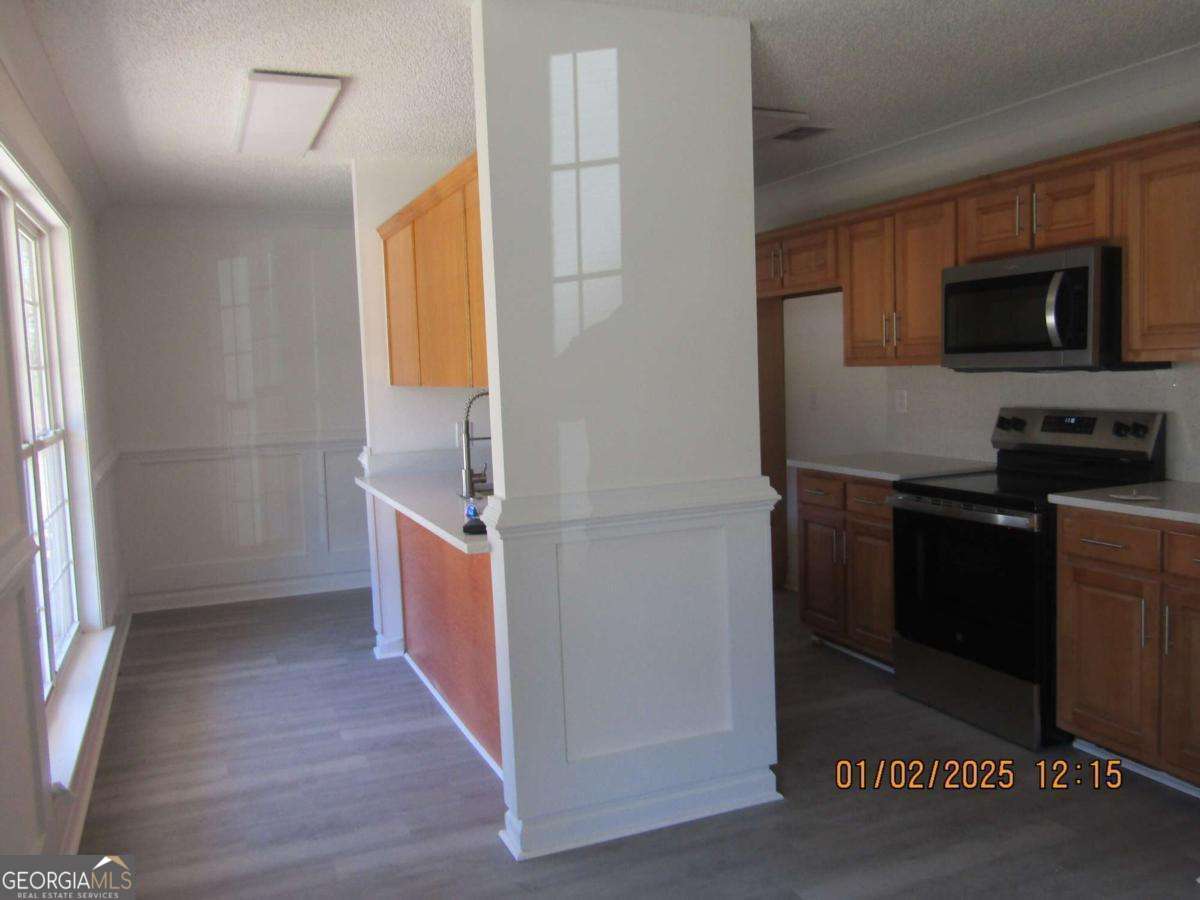 7358 Stilson-Leefield Road Brooklet, GA 30415 - Photo 9 of 24 a kitchen with a refrigerator and a stove top oven