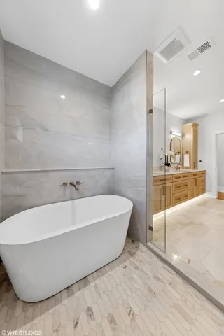 a spacious bathroom with a bathtub and sink