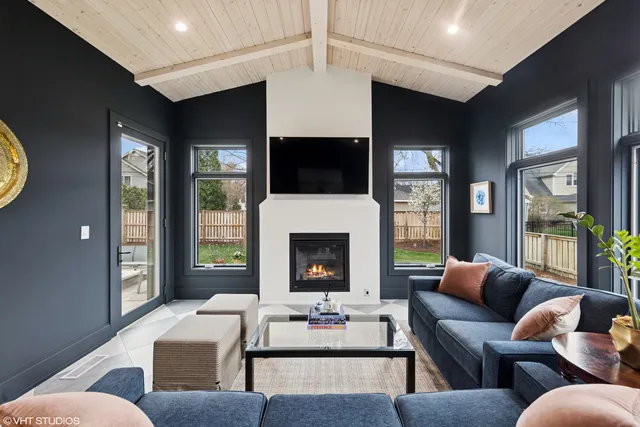 a living room with furniture a fireplace and a flat screen tv