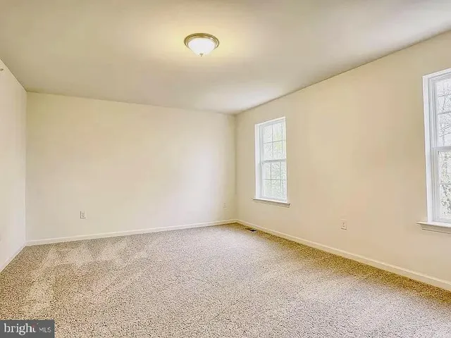 an empty room with a windows