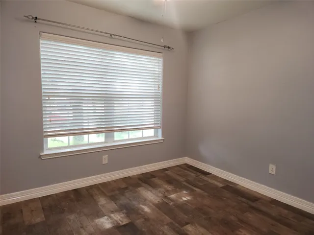 a kitchen with stainless steel appliances granite countertop a stove top oven a sink and dishwasher with wooden floor