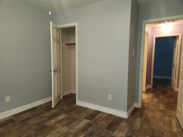 a stove top oven sitting inside of a kitchen with granite countertop wooden cabinets