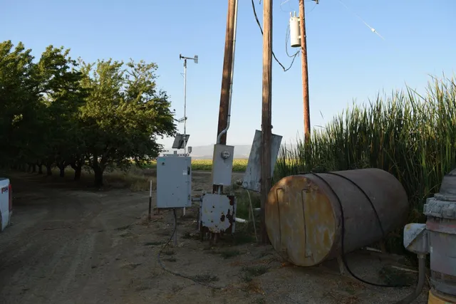 a view of a tall white house with a sink and yard