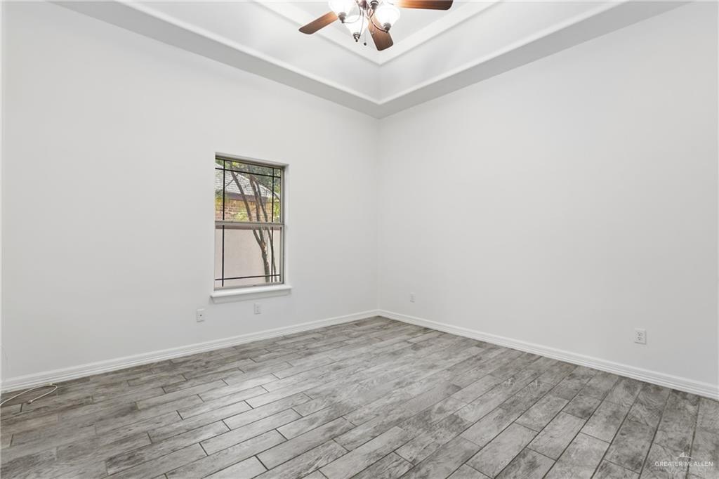 513 Mi Vida Street Weslaco, TX 78596 - Photo 12 of 22 an empty room with a window and a ceiling fan