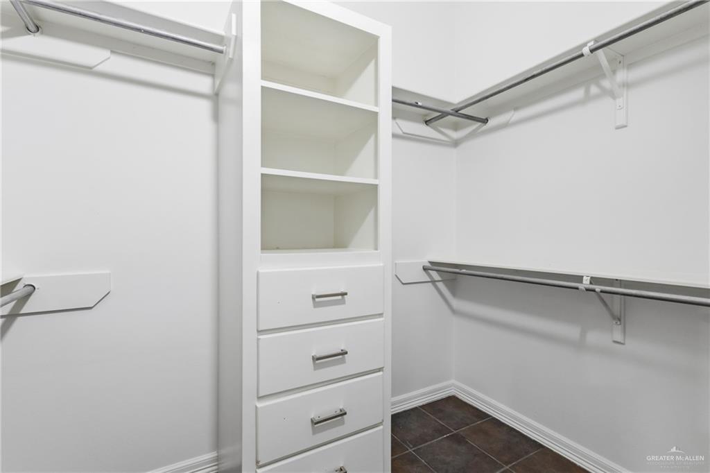 513 Mi Vida Street Weslaco, TX 78596 - Photo 16 of 22 a view of walk in closet with empty racks