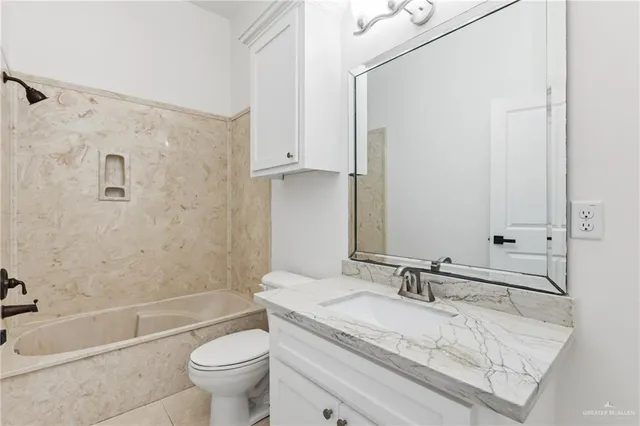 a white toilet sitting next to a shower