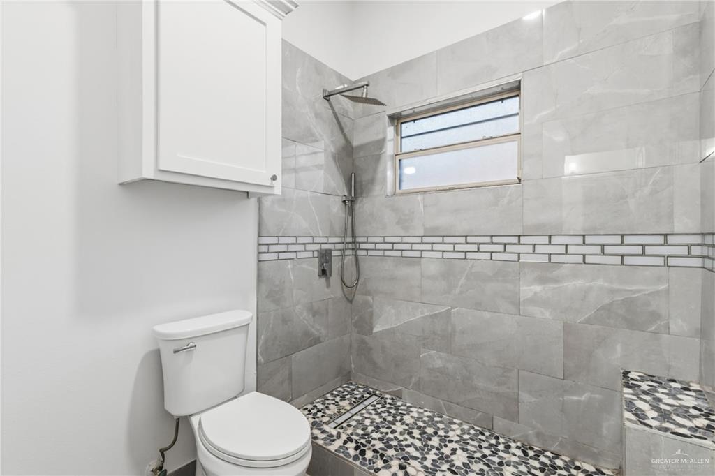 513 Mi Vida Street Weslaco, TX 78596 - Photo 19 of 22 a white toilet sitting next to a shower