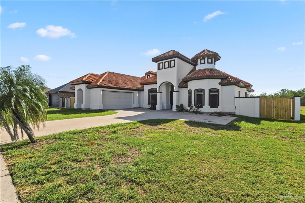 513 Mi Vida Street Weslaco, TX 78596 - Photo 2 of 22 a front view of a house with a yard