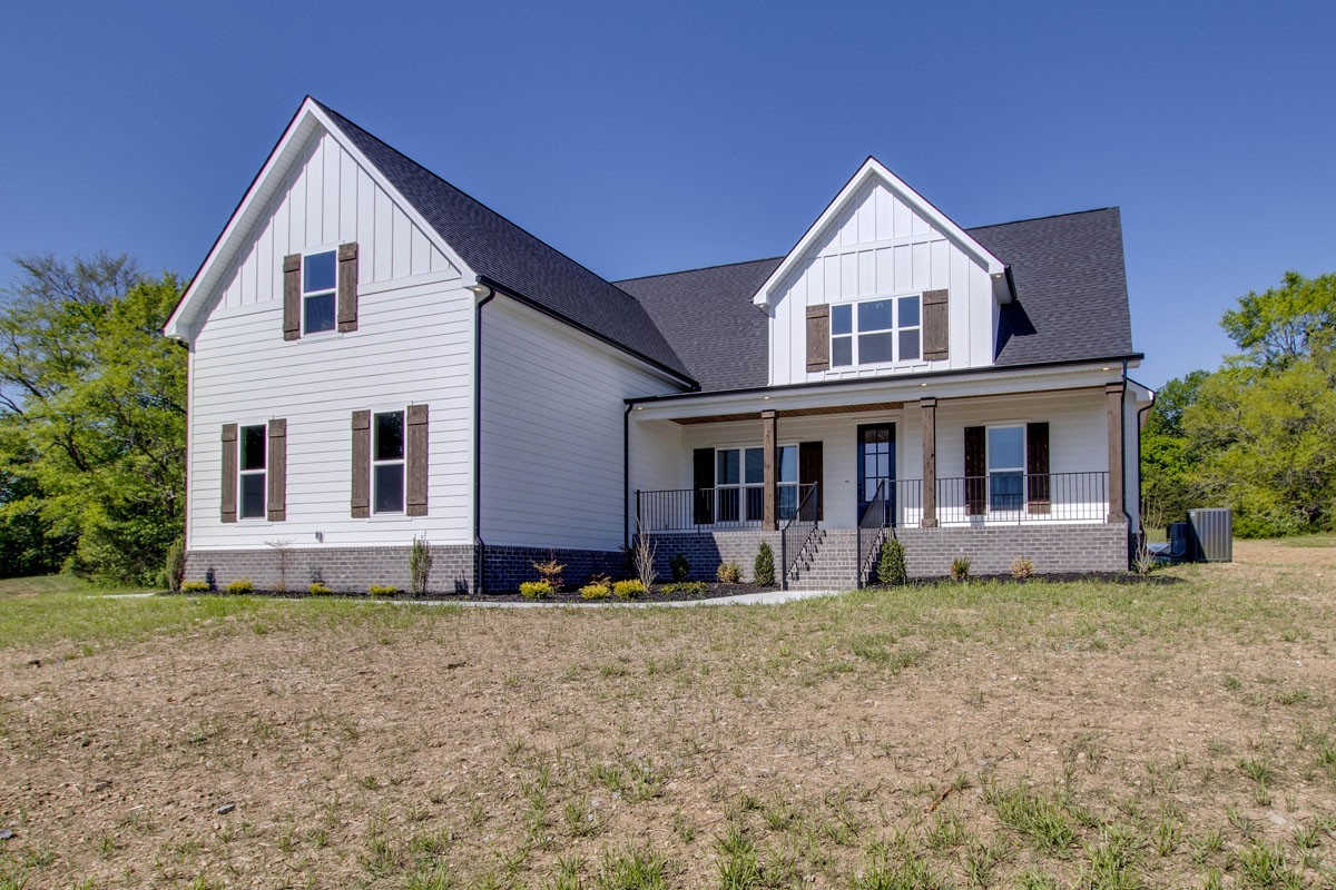 7311 North Milton Road Milton, TN 37118 - Photo 2 of 54 a view of a yard in front of a house with large windows