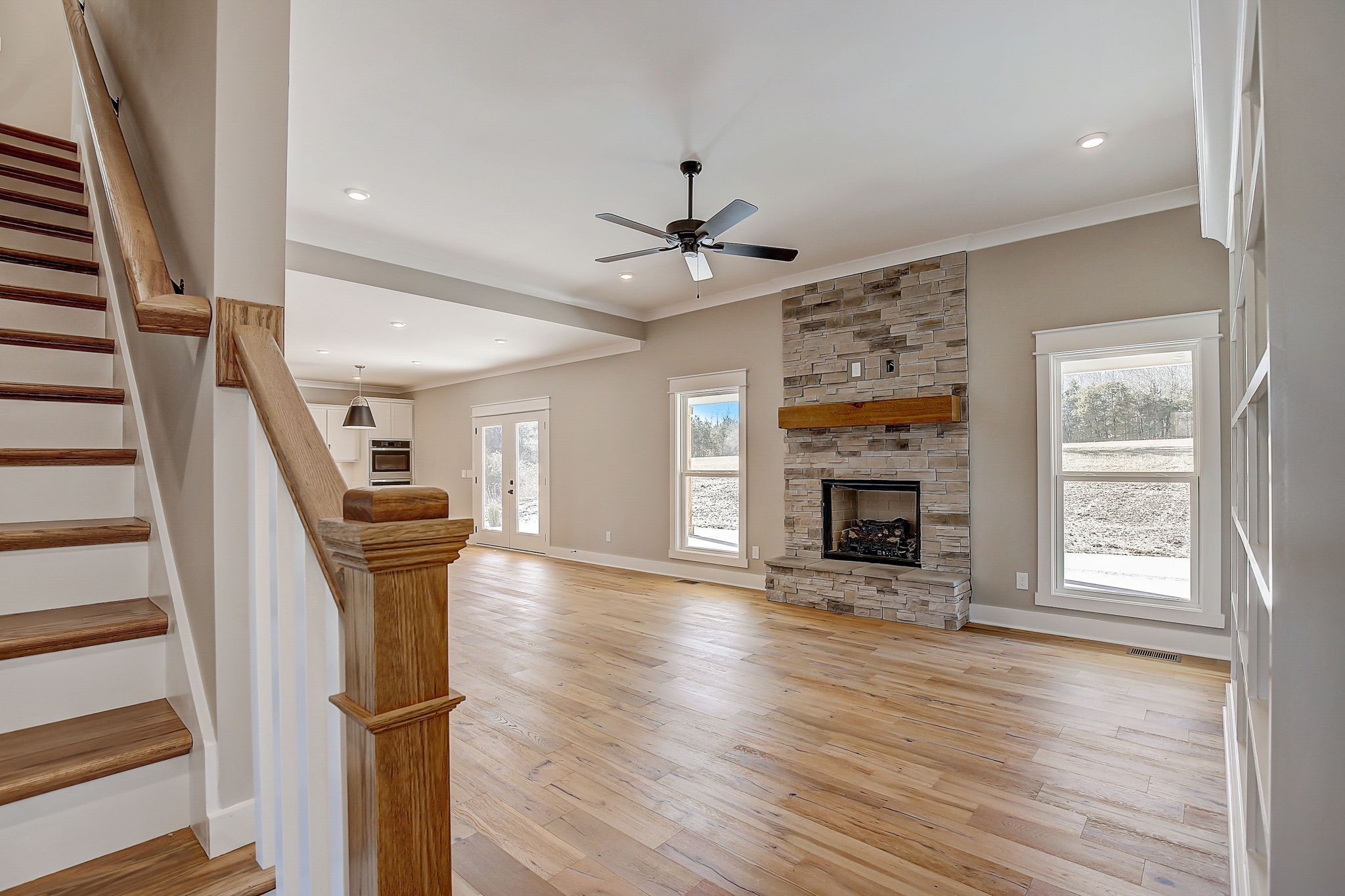 7311 North Milton Road Milton, TN 37118 - Photo 10 of 54 wooden floor in an empty room with a fireplace and a window