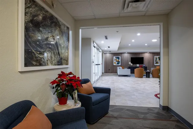 a living room with furniture and flowers