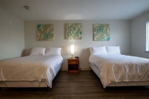 a bedroom with a bed and painting on the wall