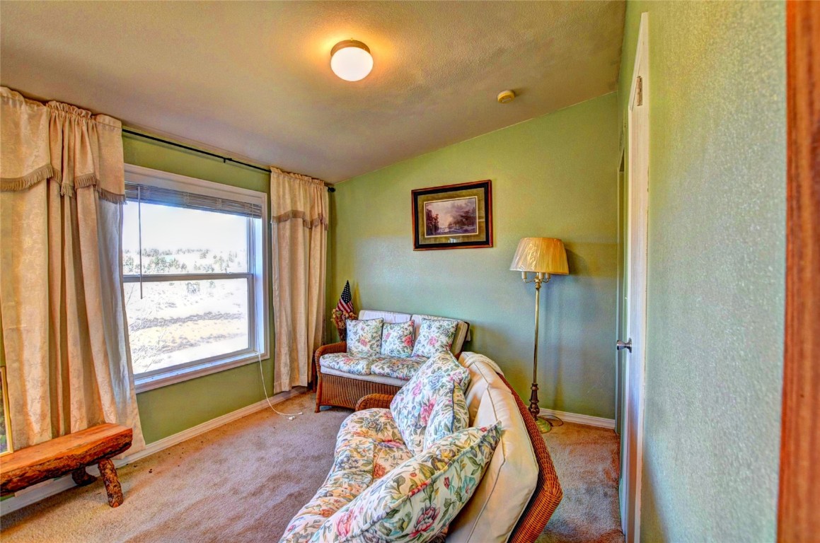 735 Apache Trail Como, CO 80456 - Photo 8 of 37 a bed sitting in a bedroom next to a window