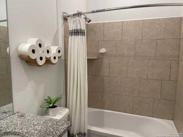 a living room with furniture and wall paintings