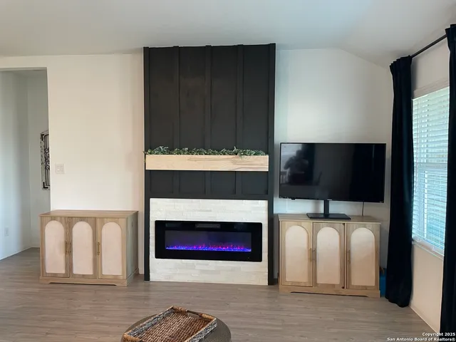 a living room with furniture and large windows