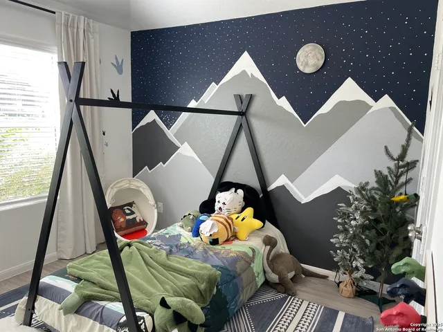 a bedroom with bed and window