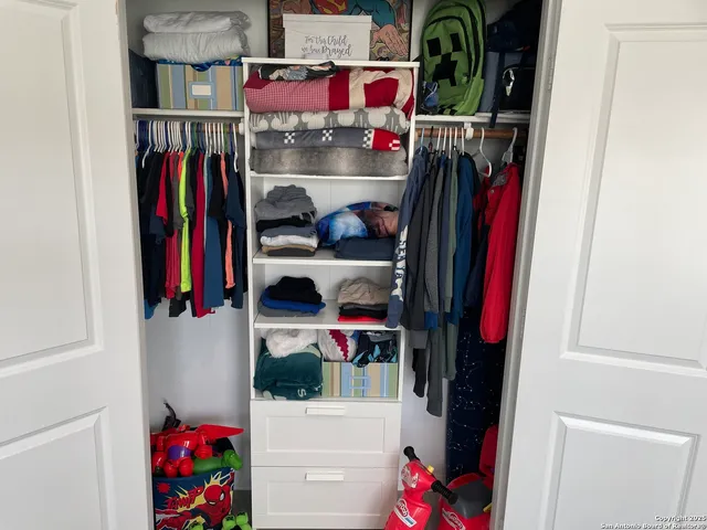 a cabinet with storage and utility racks on the wall