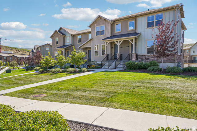 1107 West Wasatch Springs Road, Unit M3 Heber City, UT 84036 - Photo 2 of 34 Townhome exterior featuring varied siding, stone accents, covered entryways, and mature landscaping