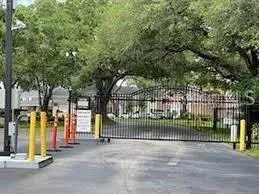a view of a park with iron fence